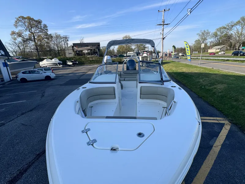 Slide: The Image of 2023 Key West 203 DFS boat with spacious seating, parked outdoors on a sunny day. - 25