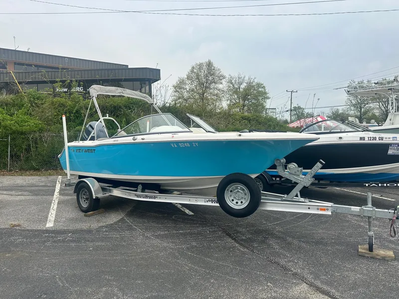 Slide: The Image of 2023 Key West 203 DFS boat on trailer, parked outdoors. - 5
