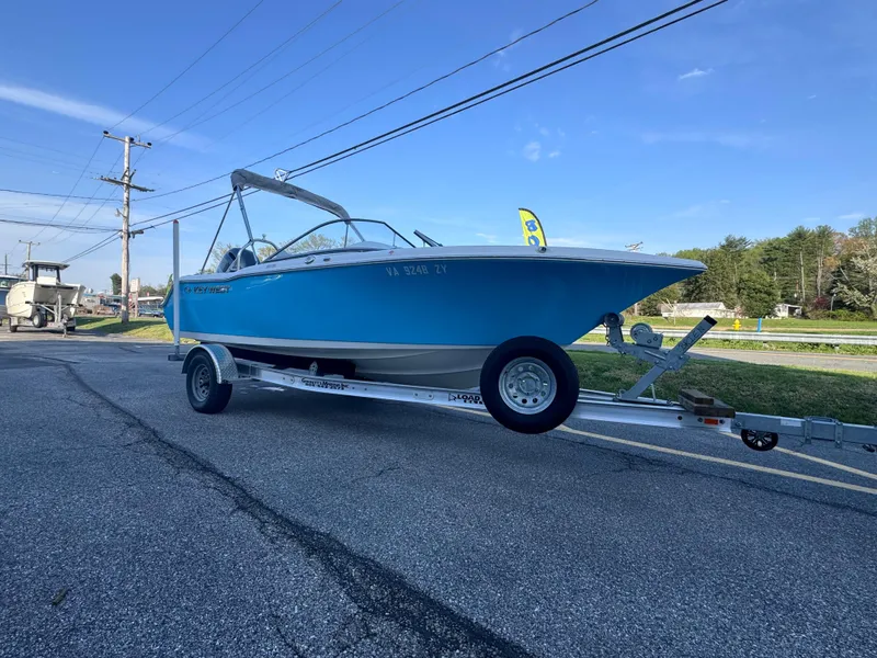 Slide: The Image of 2023 Key West 203 DFS boat on trailer, parked on roadside under clear sky. - 9