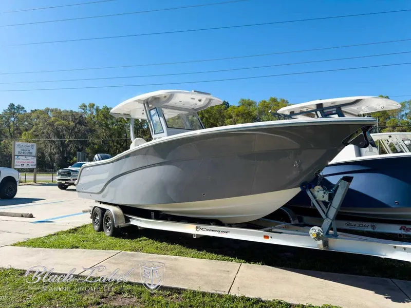 Slide: The Image of 2025 Sea Fox 288 Commander boat on trailer, parked outdoors under clear blue sky. - 1
