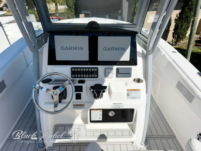 Slide: The Image of 2025 Sea Fox 288 Commander helm with dual Garmin displays and steering wheel. - 12