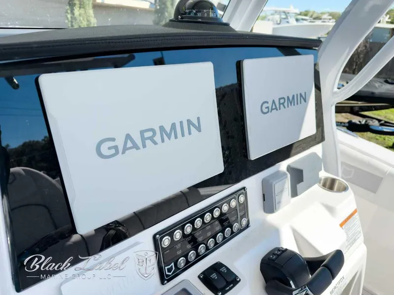 Slide: The Image of 2025 Sea Fox 288 Commander dashboard with dual Garmin displays and control panel. - 13