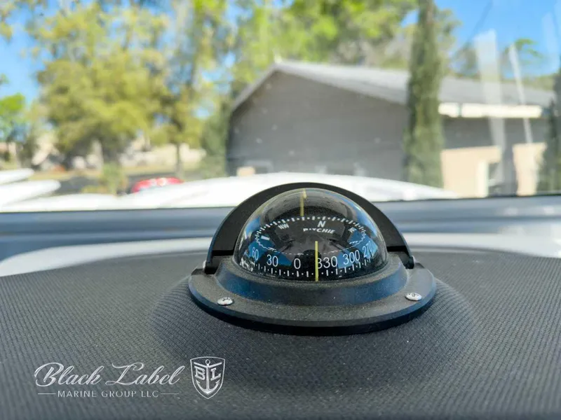 Slide: The Image of Compass on Sea Fox 288 Commander dashboard, 2025 model, with Black Label Marine Group logo. - 17