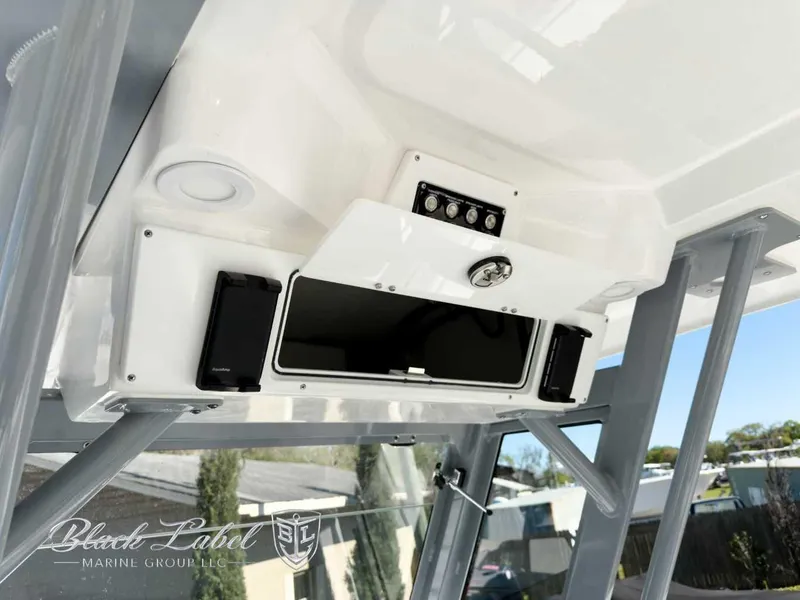 Slide: The Image of 2025 Sea Fox 288 Commander boat console with storage and controls, Black Label Marine Group branding. - 19