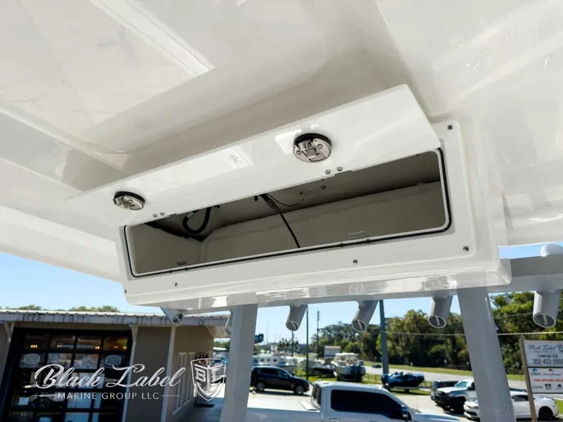 Slide: The Image of 2025 Sea Fox 288 Commander storage compartment with open hatch, showcasing interior space. - 21