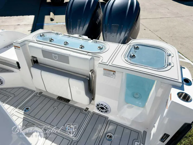 Slide: The Image of 2025 Sea Fox 288 Commander boat deck with storage compartments and dual engines. - 22