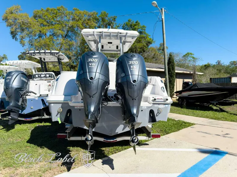 Slide: The Image of 2025 Sea Fox 288 Commander with twin Yamaha 300 V6 engines, parked outdoors. - 3