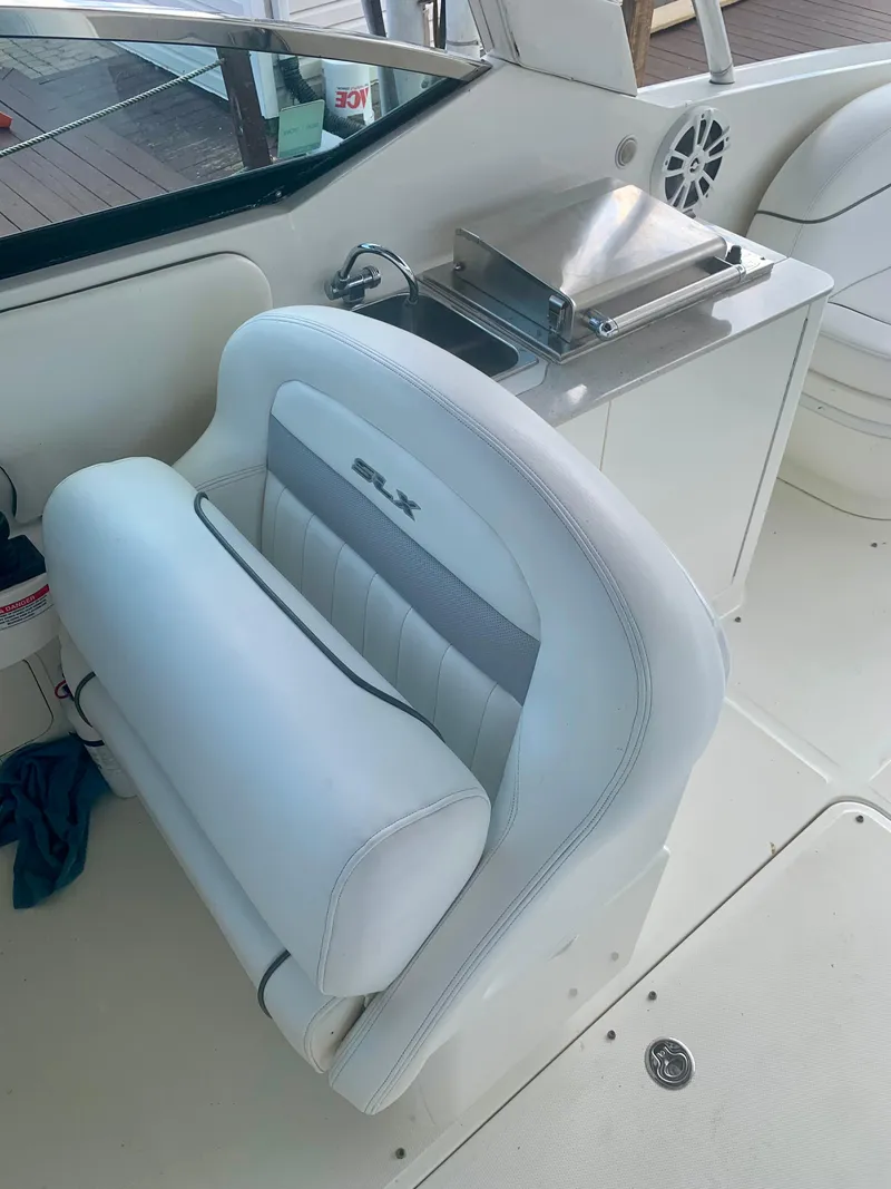 Slide: The Image of 2009 Sea Ray 300 SLX boat interior with white seating and stainless steel fixtures. - 10