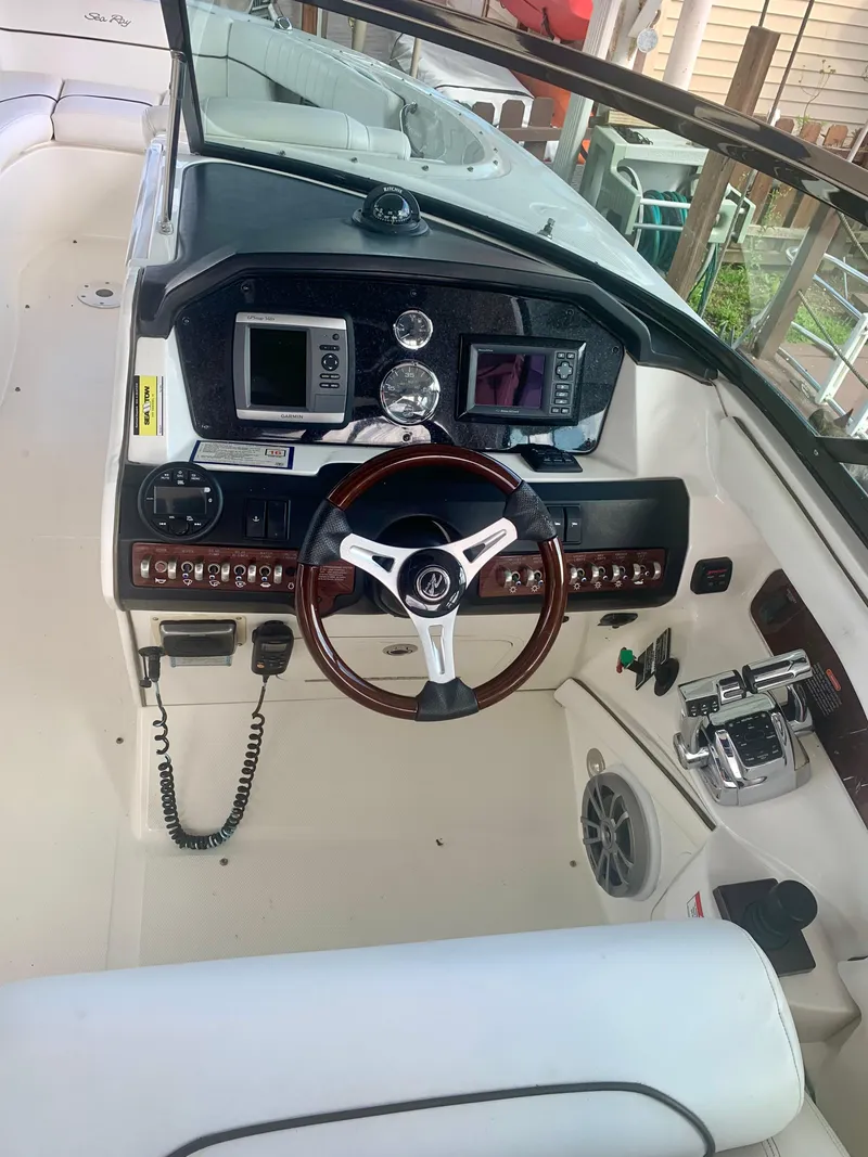 Slide: The Image of 2009 Sea Ray 300 SLX boat dashboard with steering wheel and control panel. - 6