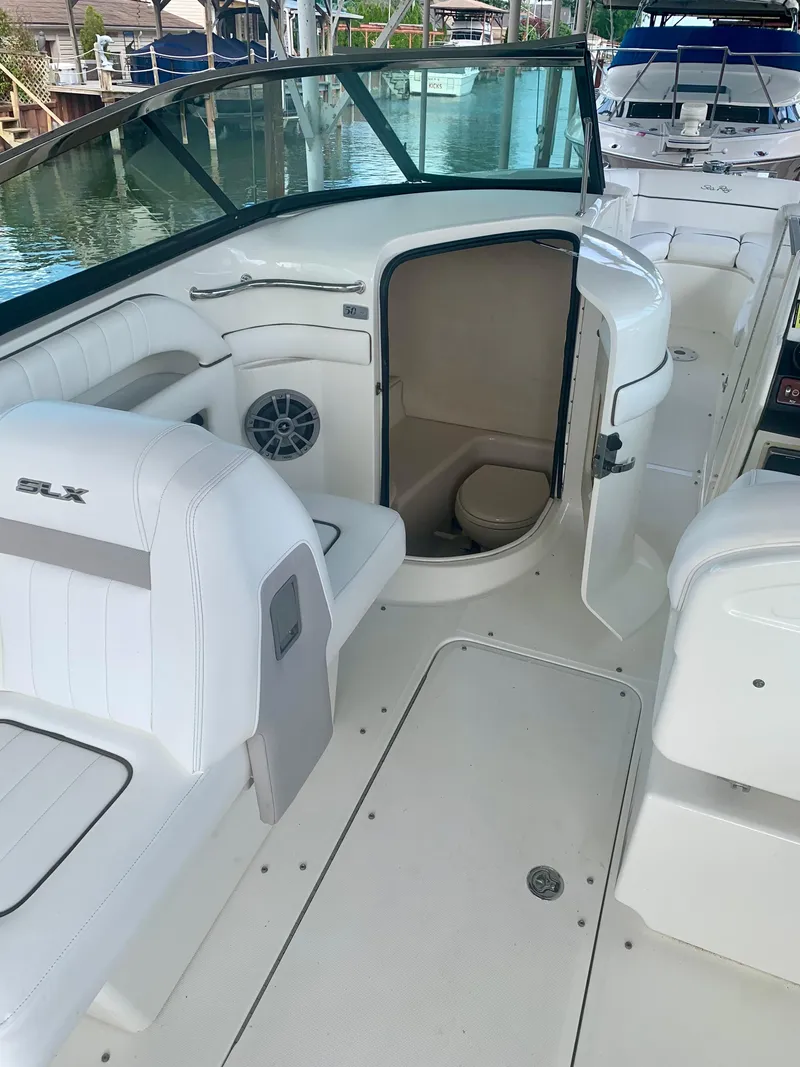 Slide: The Image of 2009 Sea Ray 300 SLX boat interior with seating and open cabin door. - 7