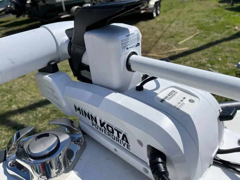 Slide: The Image of Minn Kota PowerDrive motor on 2024 Boston Whaler 150 Montauk boat, outdoor setting. - 17