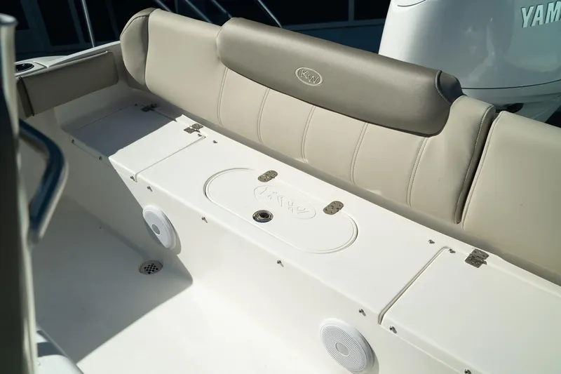Slide: The Image of 2024 Key West 219 FS boat seating area with beige upholstery and integrated speakers. - 2