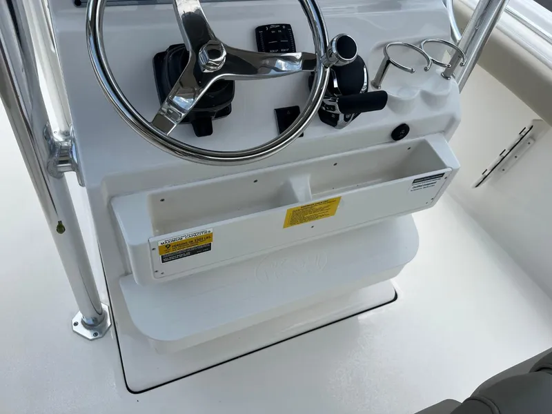 Slide: The Image of 2024 Key West 239 FS boat console with steering wheel and controls. - 10