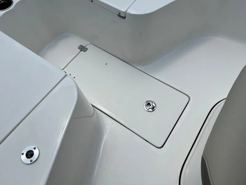 Slide: The Image of 2024 Key West 239 FS boat interior with storage compartment and sleek design. - 17