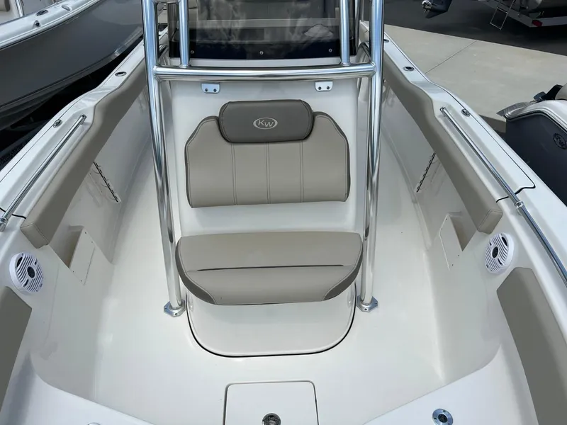 Slide: The Image of 2024 Key West 239 FS boat interior with cushioned seating and stainless steel railings. - 19