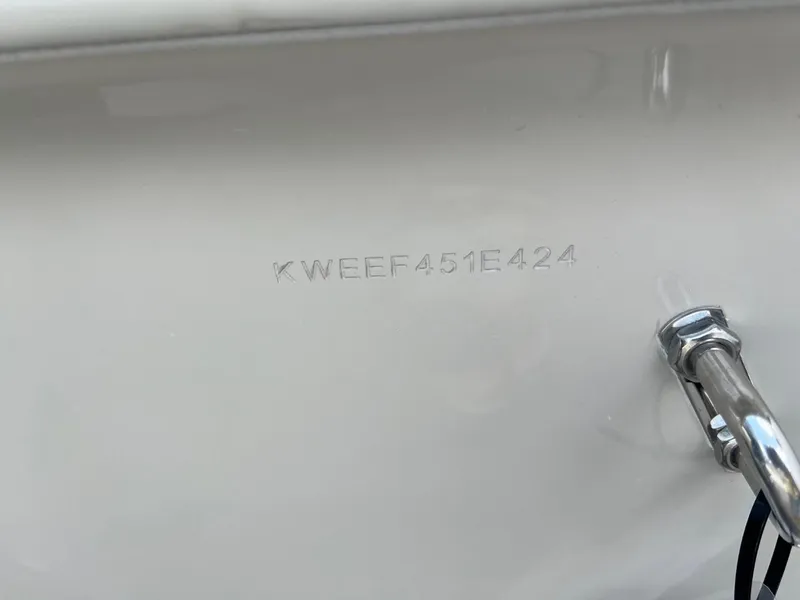 Slide: The Image of 2024 Key West 239 FS boat hull identification number (HIN) engraved on white surface. - 21