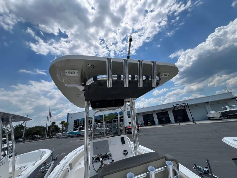 Slide: The Image of 2024 Key West 239 FS boat with T-top and rod holders under a partly cloudy sky. - 7