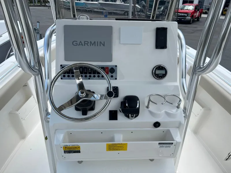 Slide: The Image of 2024 Key West 239 FS boat console with Garmin display and steering wheel. - 8
