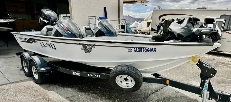 Slide: The Image of 2018 Lund 1875 Pro-V Bass boat on trailer, parked outdoors. - 7