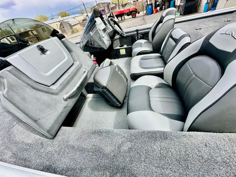Slide: The Image of 2018 Lund 1875 Pro-V Bass boat interior with gray and black seating. - 9