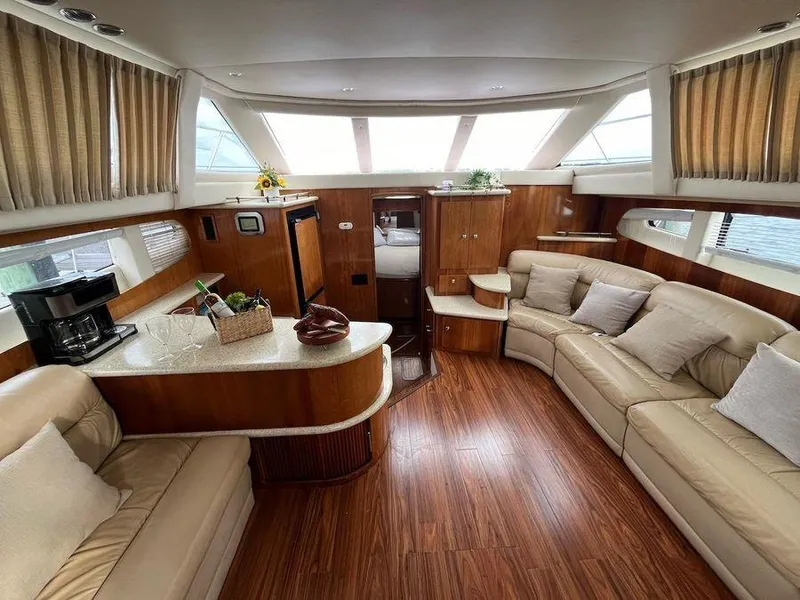 Slide: The Image of Luxurious interior of 2000 Carver 396 Motor Yacht with plush seating and wood accents. - 18