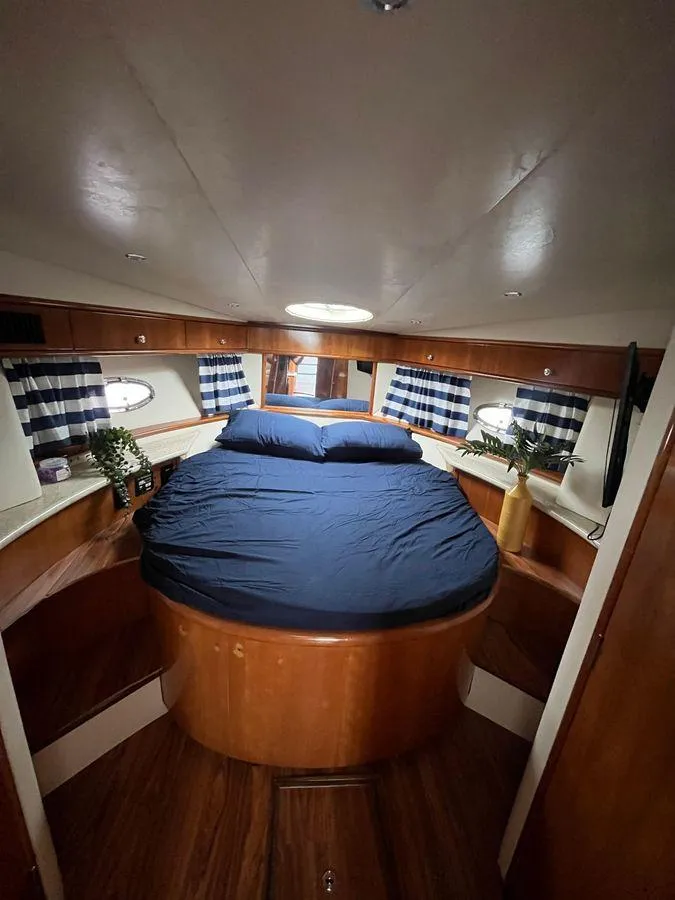 Slide: The Image of Interior of 2000 Carver 396 Motor Yacht with cozy bedroom and nautical decor. - 22