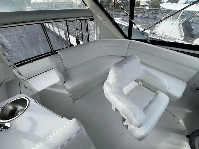 Slide: The Image of Interior of 2000 Carver 396 Motor Yacht with white seating and windows. - 8
