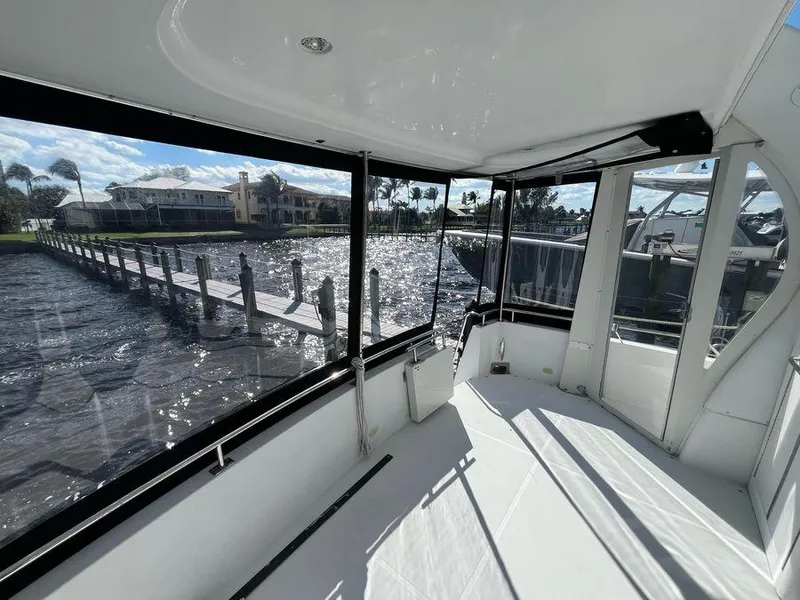 Slide: The Image of 2000 Carver 396 Motor Yacht interior with marina view through large windows. - 11