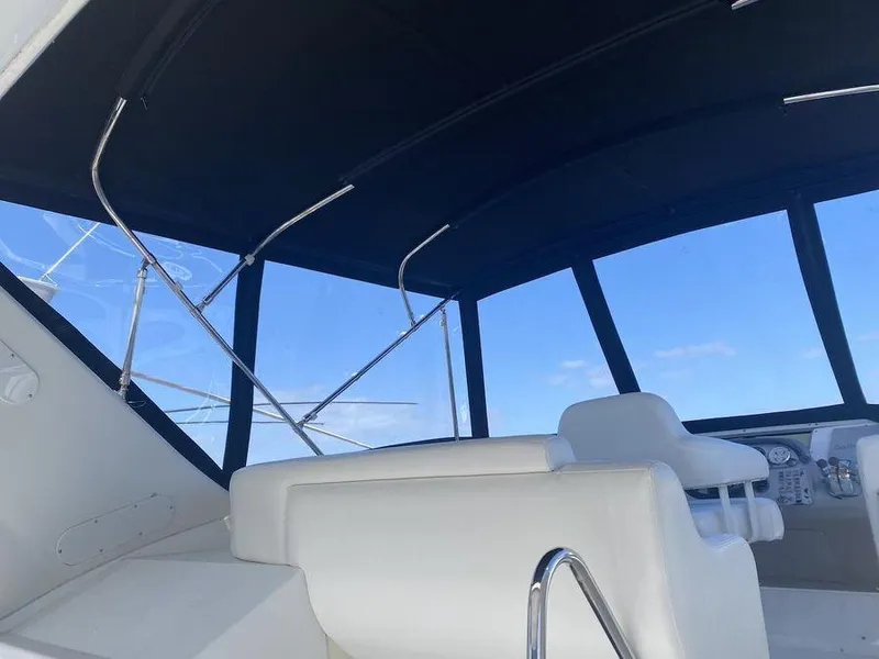 Slide: The Image of Interior view of 2000 Carver 396 Motor Yacht with white seating and large windows. - 12