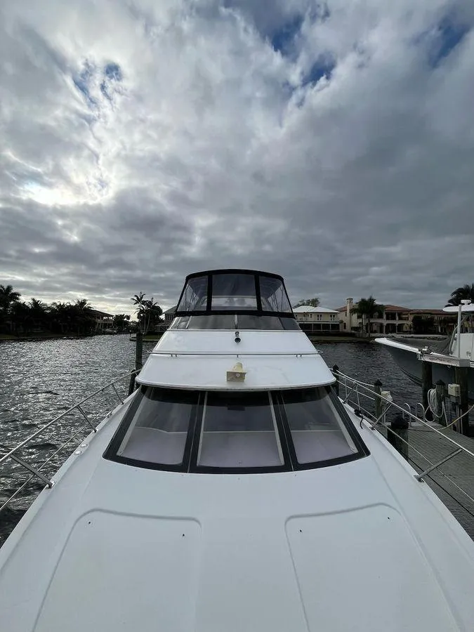 Slide: The Image of 2000 Carver 396 Motor Yacht docked under cloudy skies. - 15