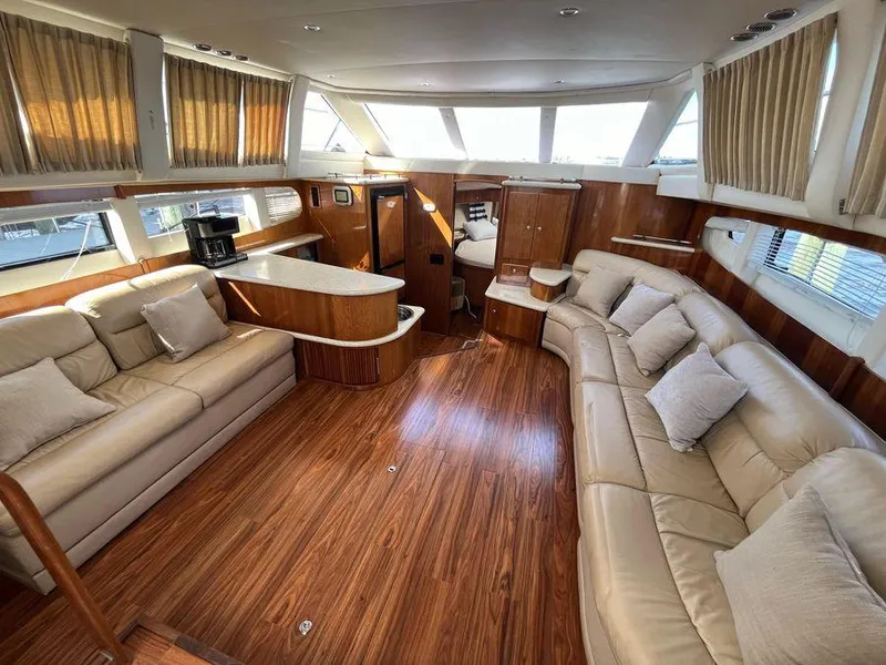 Slide: The Image of Luxurious interior of 2000 Carver 396 Motor Yacht with plush seating and wood finishes. - 17