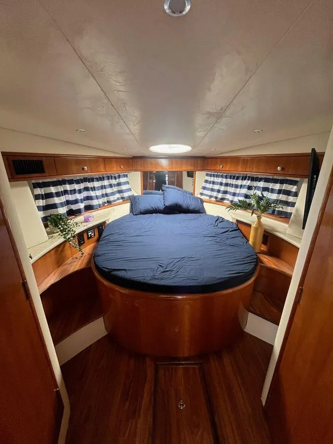 Slide: The Image of Interior of 2000 Carver 396 Motor Yacht with cozy bed and nautical decor. - 23