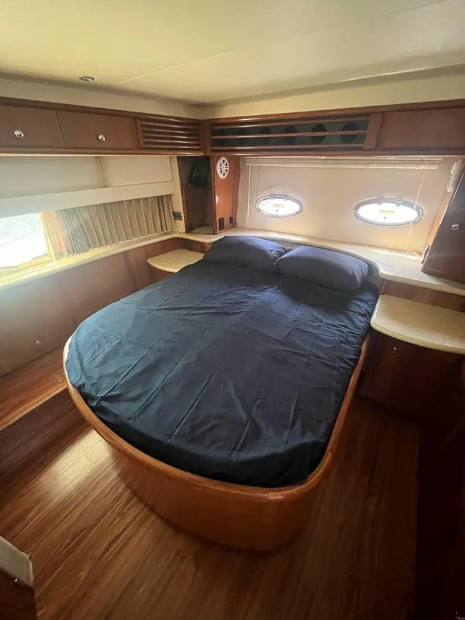 Slide: The Image of Interior cabin of 2000 Carver 396 Motor Yacht with bed and porthole windows. - 25