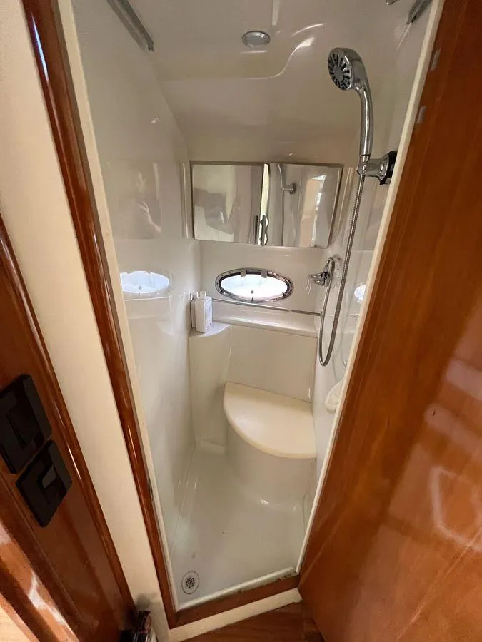 Slide: The Image of Compact shower in 2000 Carver 396 Motor Yacht with oval window and modern fixtures. - 27