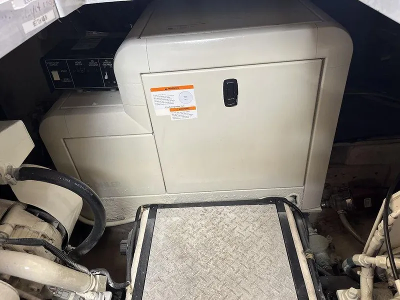 Slide: The Image of Engine room of 2000 Carver 396 Motor Yacht with generator and mechanical components. - 29
