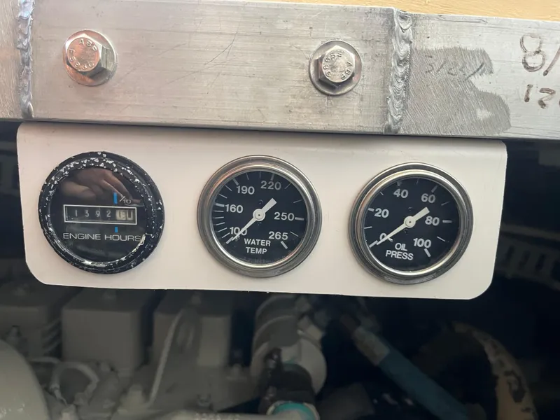 Slide: The Image of Gauges on a 2000 Carver 396 Motor Yacht displaying engine hours, water temperature, and oil pressure. - 34
