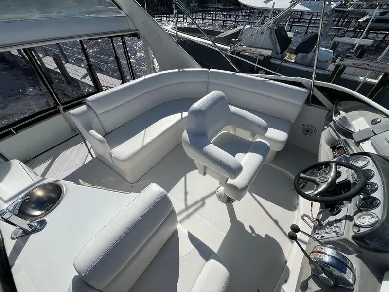 Slide: The Image of Spacious deck of 2000 Carver 396 Motor Yacht with white seating and control panel. - 4