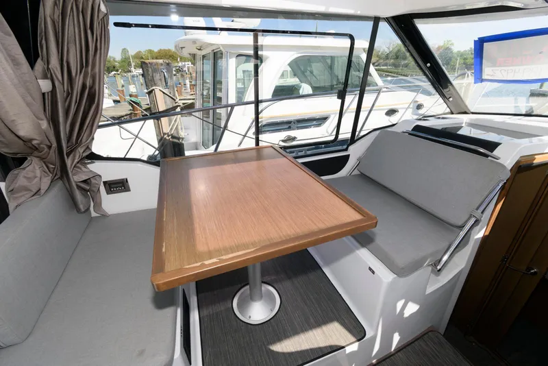 Slide: The Image of Interior of 2019 Jeanneau NC 895 boat with dining area and seating. - 10