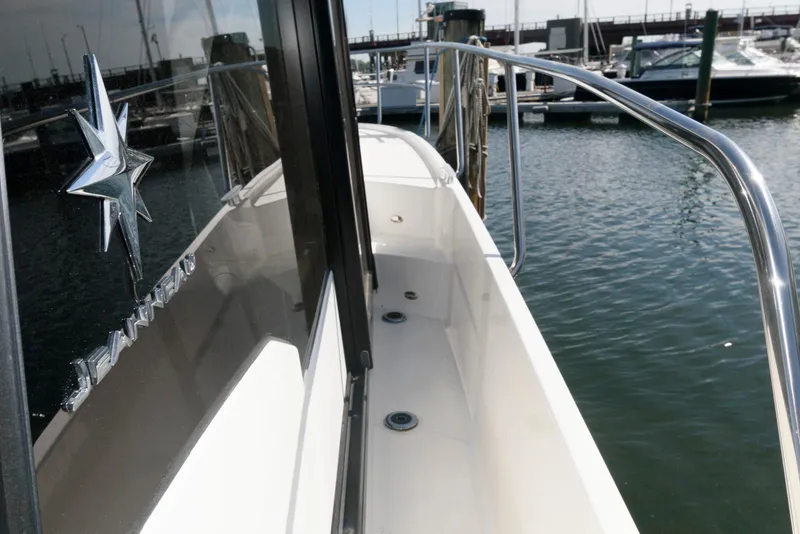 Slide: The Image of 2019 Jeanneau NC 895 boat docked, showing side deck and railing. - 13