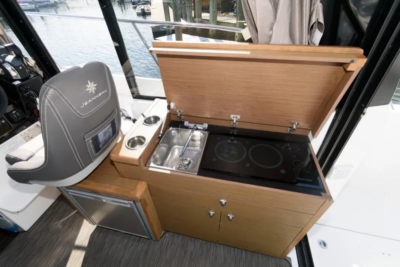 Slide: The Image of 2019 Jeanneau NC 895 boat interior with kitchenette and captain's chair. - 14