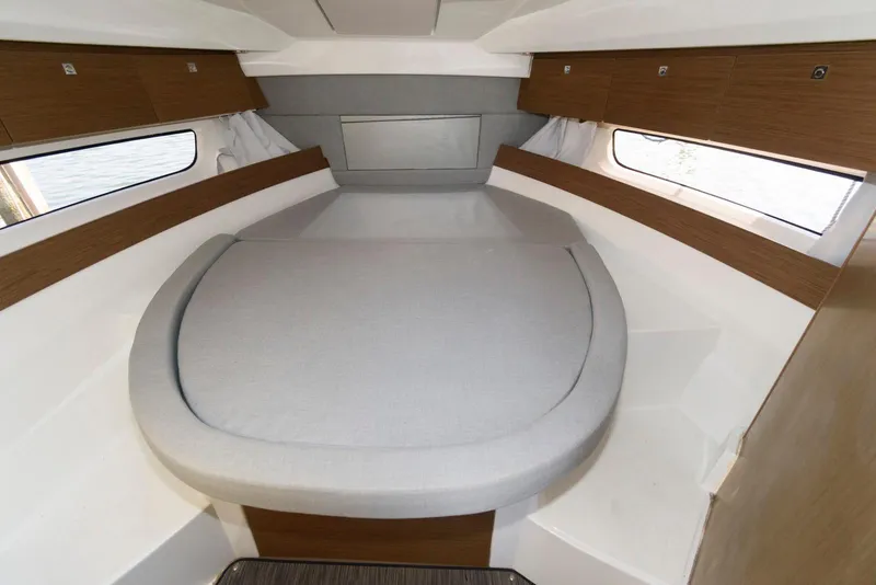 Slide: The Image of 2019 Jeanneau NC 895 cabin interior with cozy bed and wooden accents. - 15