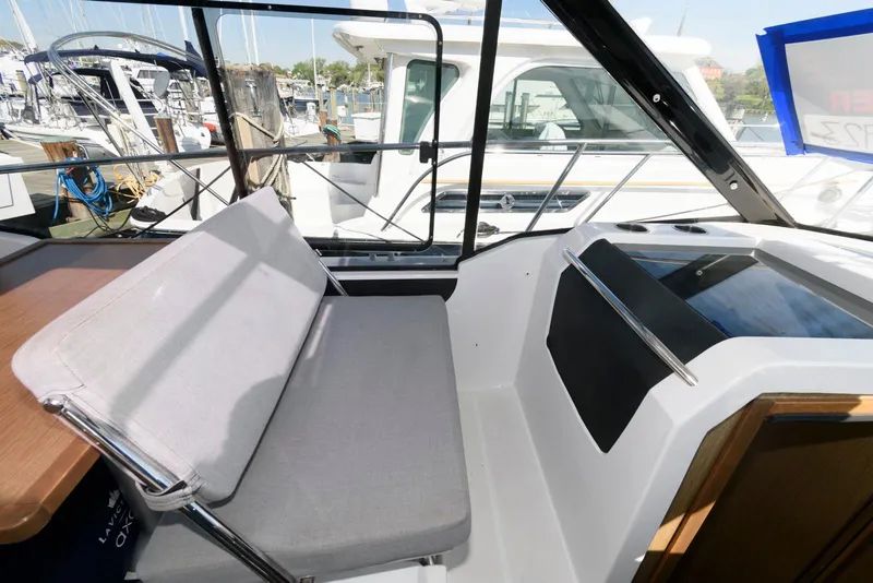 Slide: The Image of 2019 Jeanneau NC 895 boat interior with seating and window view. - 17