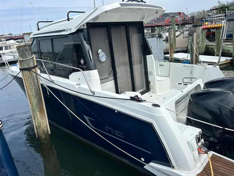 Slide: The Image of 2019 Jeanneau NC 895 boat docked at marina, featuring sleek design and modern amenities. - 2
