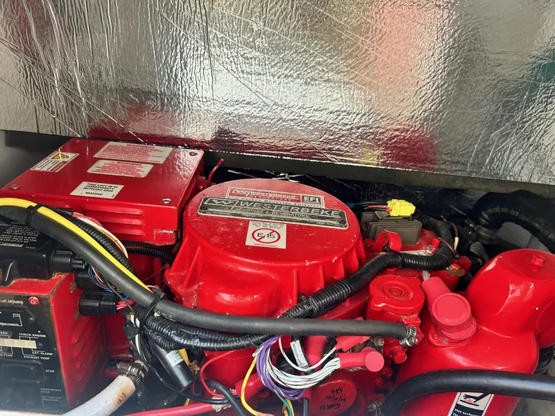 Slide: The Image of Engine compartment of a 2019 Jeanneau NC 895 boat, featuring red components and wiring. - 21
