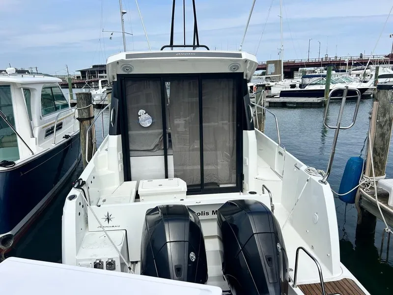 Slide: The Image of 2019 Jeanneau NC 895 boat docked with dual outboard motors, marina background. - 3