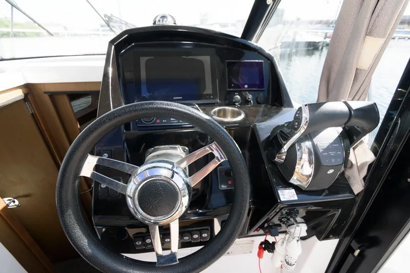 Slide: The Image of 2019 Jeanneau NC 895 helm with steering wheel and navigation controls. - 8
