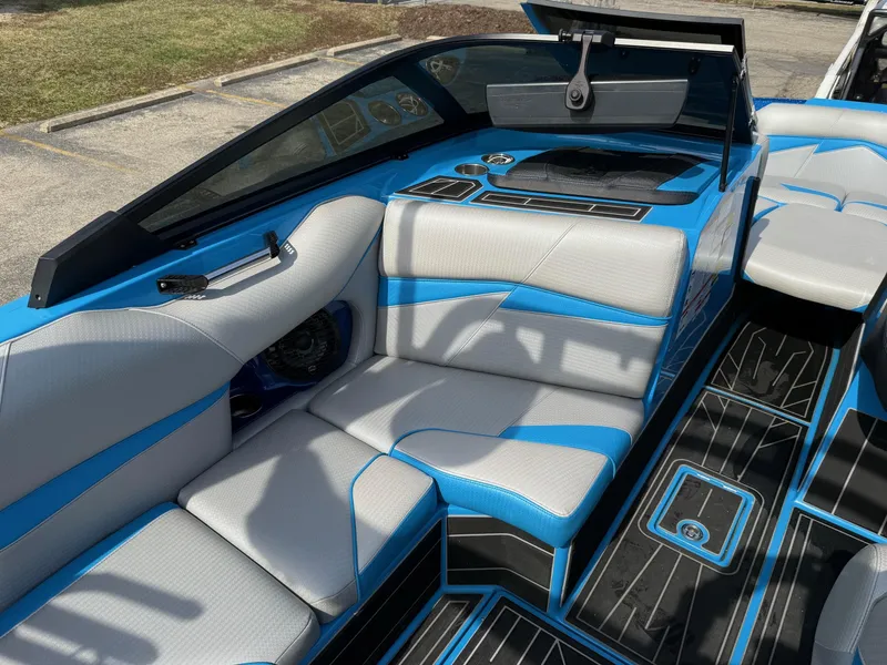 Slide: The Image of 2022 Centurion Fi23 boat interior with blue and gray seating, modern dashboard, and sleek design. - 11