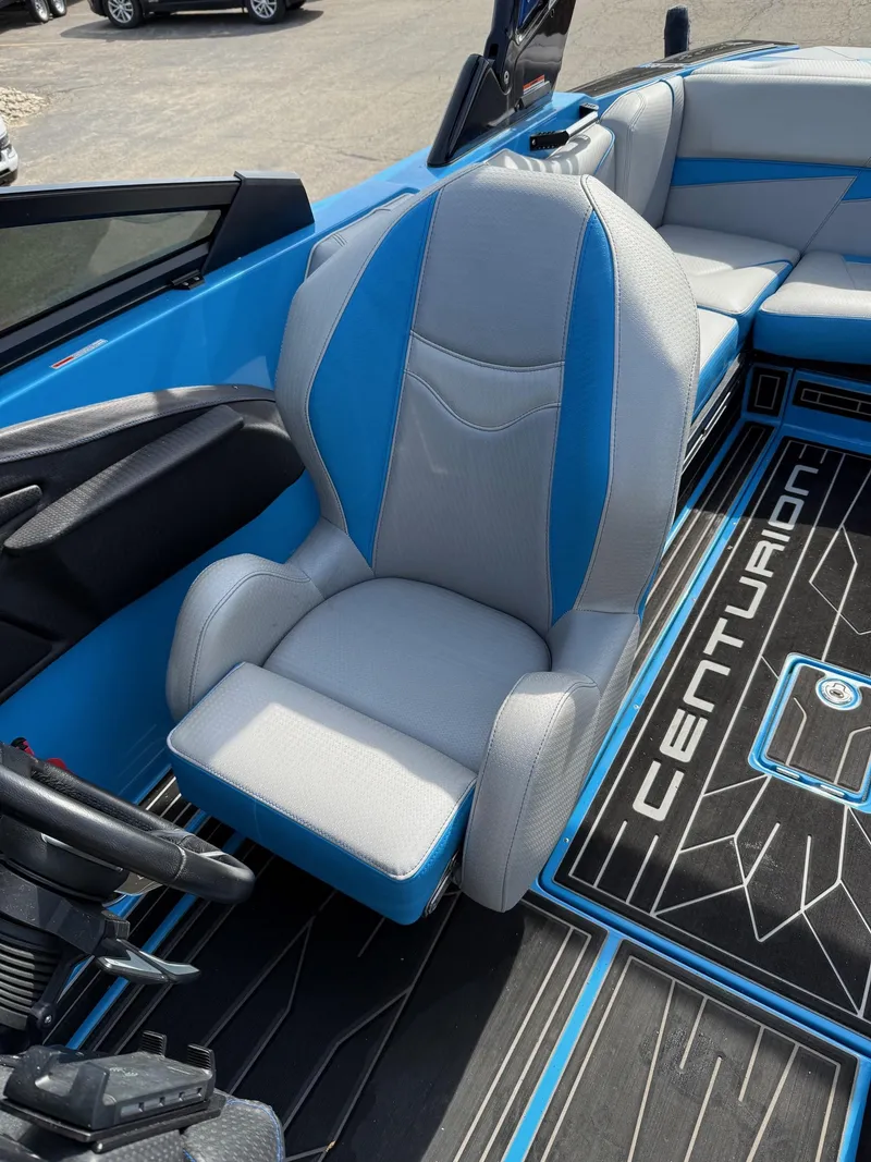 Slide: The Image of 2022 Centurion Fi23 boat interior with blue and gray seating and branded flooring. - 3
