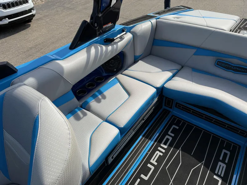 Slide: The Image of 2022 Centurion Fi23 boat interior with blue and gray seating and branded flooring. - 5