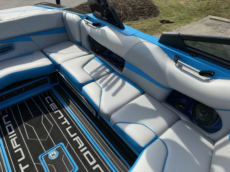 Slide: The Image of 2022 Centurion Fi23 boat interior with blue and white seating and branded flooring. - 6